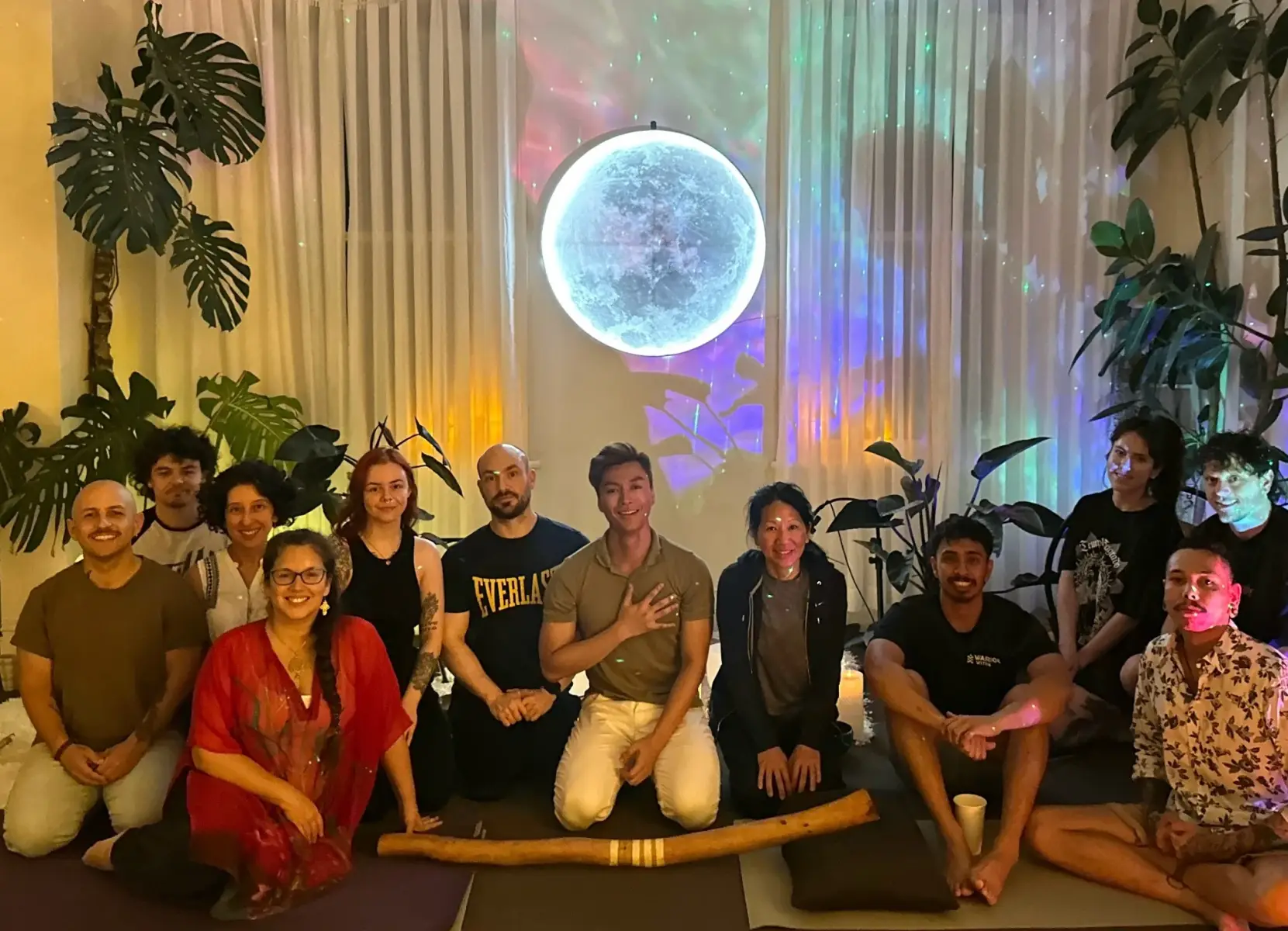 Phoenix with the Mystic Wellness community under the moon wall in Petersham