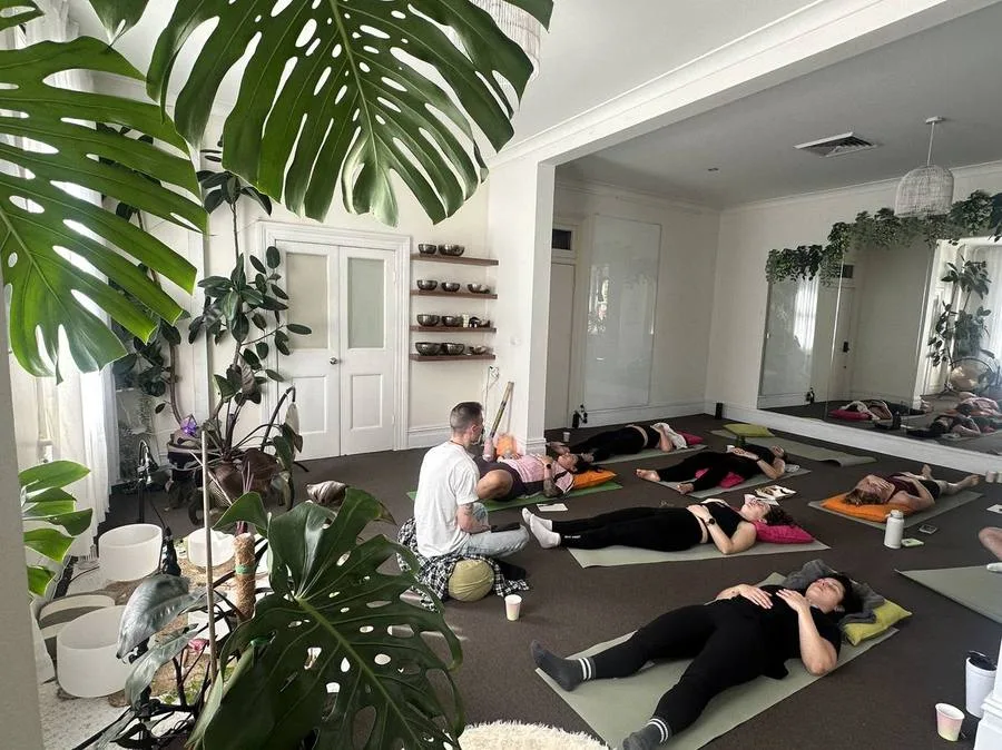 People resting in a daytime group sound healing session at Mystic Wellness Petersham