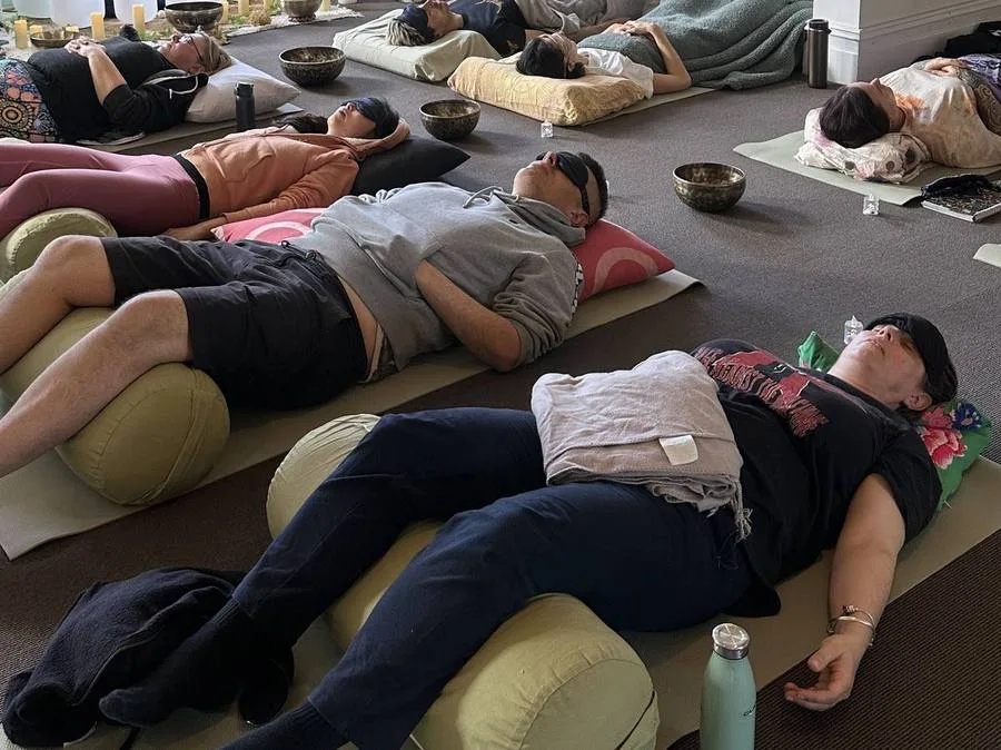 Group resting during a community sound bath session at Mystic Wellness Petersham